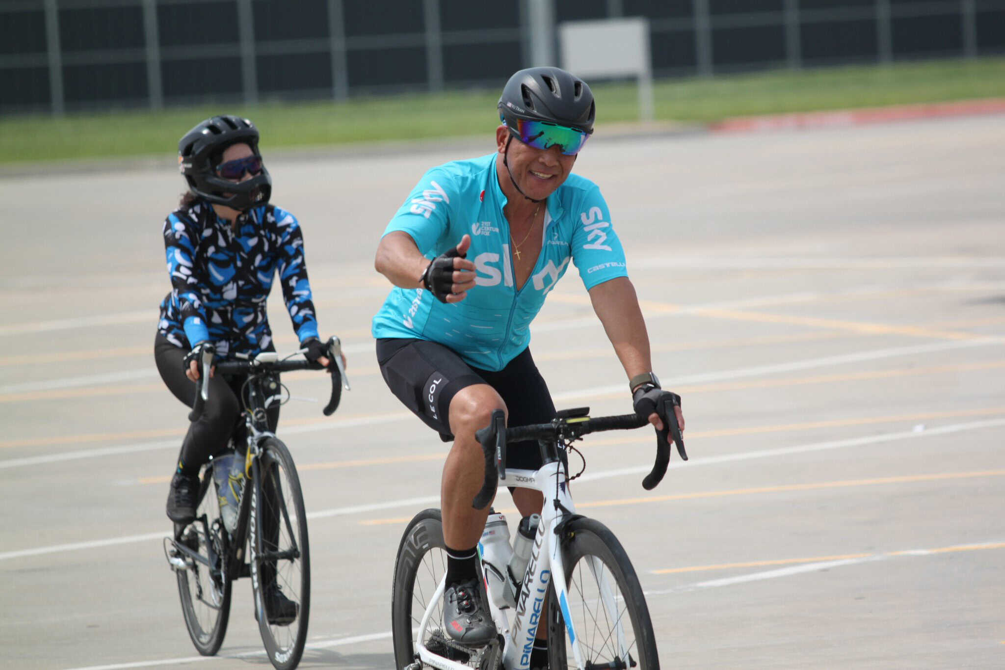 Vibrant cyclists riding on the Bluebonnet Express bike trail in daytime.