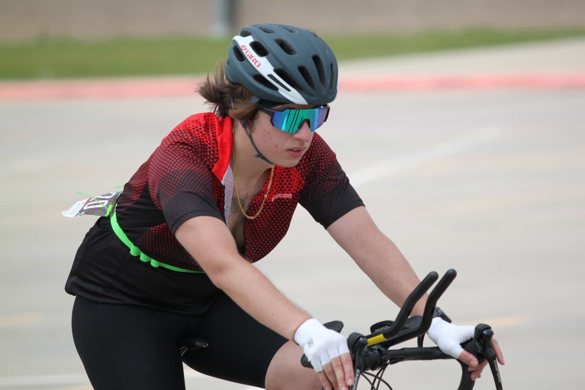 Bright young cyclist wearing safety gear at Bluebonnet Express bike race event.