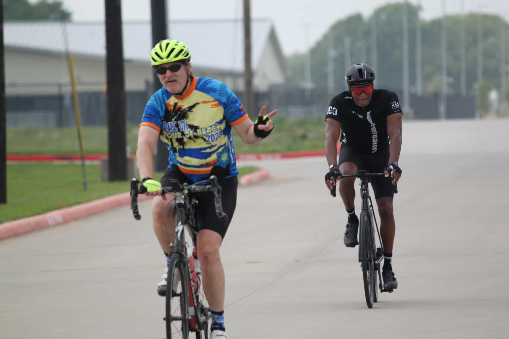 Vibrant cyclist in Bluebonnet Express jerseys riding outdoors during daytime.