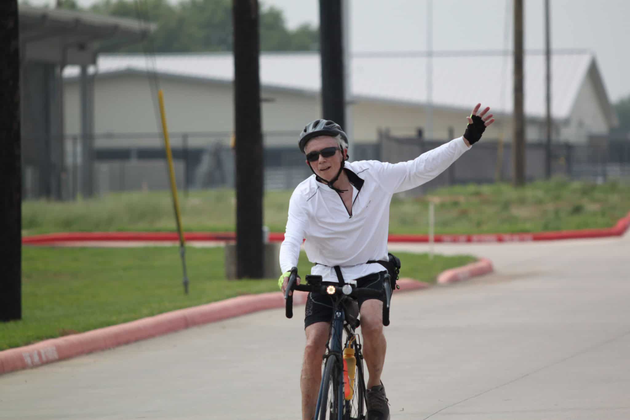 Brighton cyclist enjoying Bluebonnet Express ride on a sunny day, showcasing cycling routes and outdoor adventure.