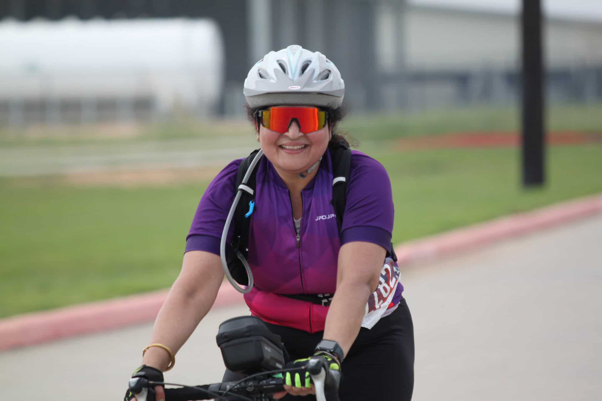Vibrant cyclist wearing sunglasses and helmet on Bluebonnet Express route for outdoor biking.