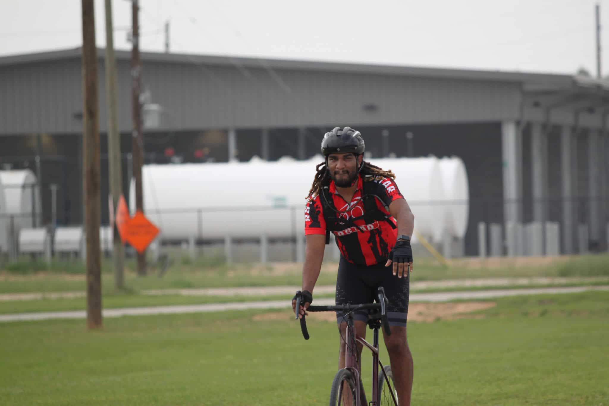 Vibrant cyclist riding on the grass in Bluebonnet Express event, showcasing outdoor biking and community engagement.