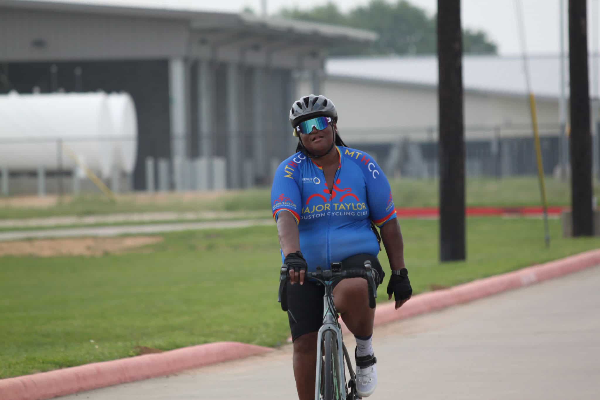 Cyclist in blue jersey riding bike outdoors, Houston cycling event, Bluebonnet Express.