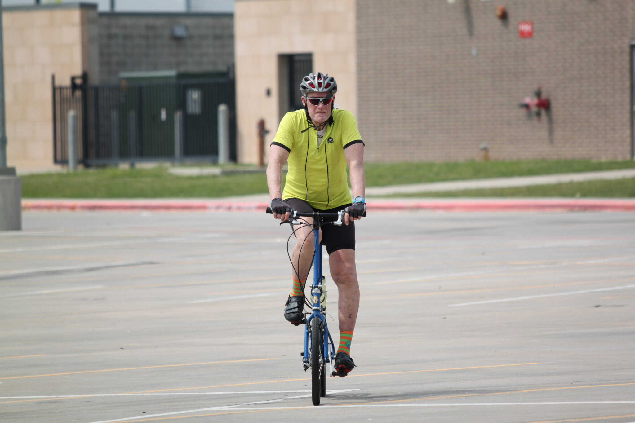 Rider on Bluebonnet Express bike ride in urban area, promoting cycling and outdoor exercise.