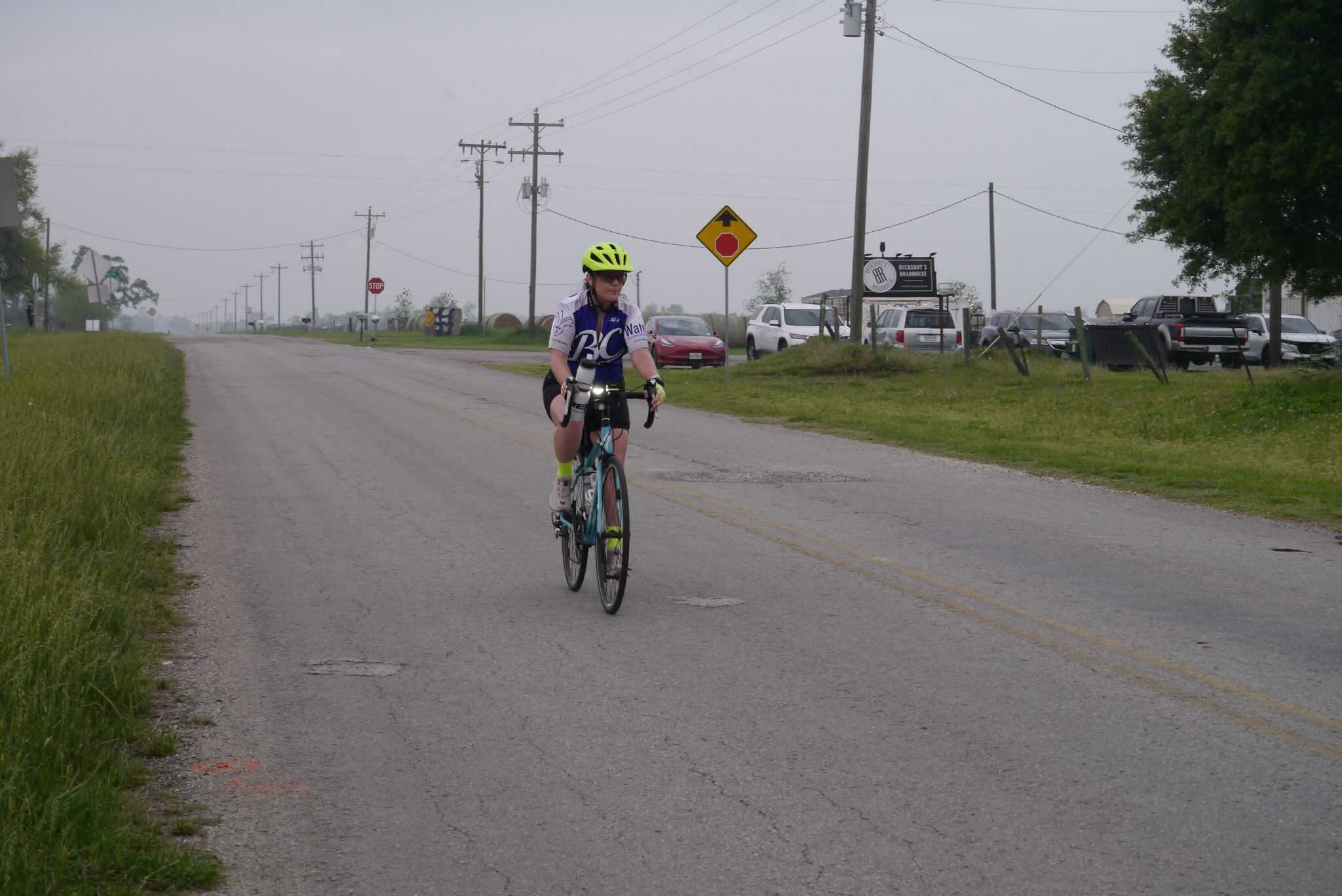 Cyclist riding on rural roadside in Bluebonnet Express bike event, comfortable cycling in scenic Texas countryside.