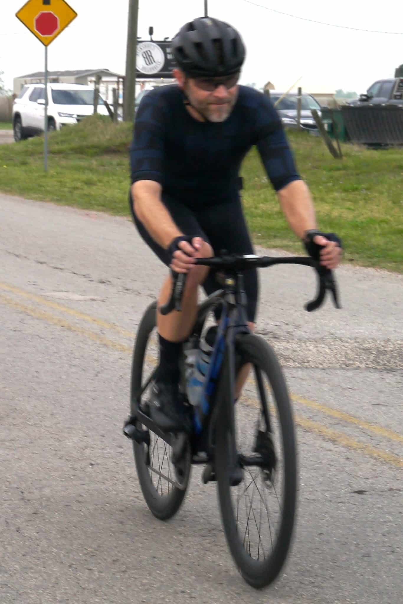 Velo cyclist riding on road in Bluebonnet Express bike gear.