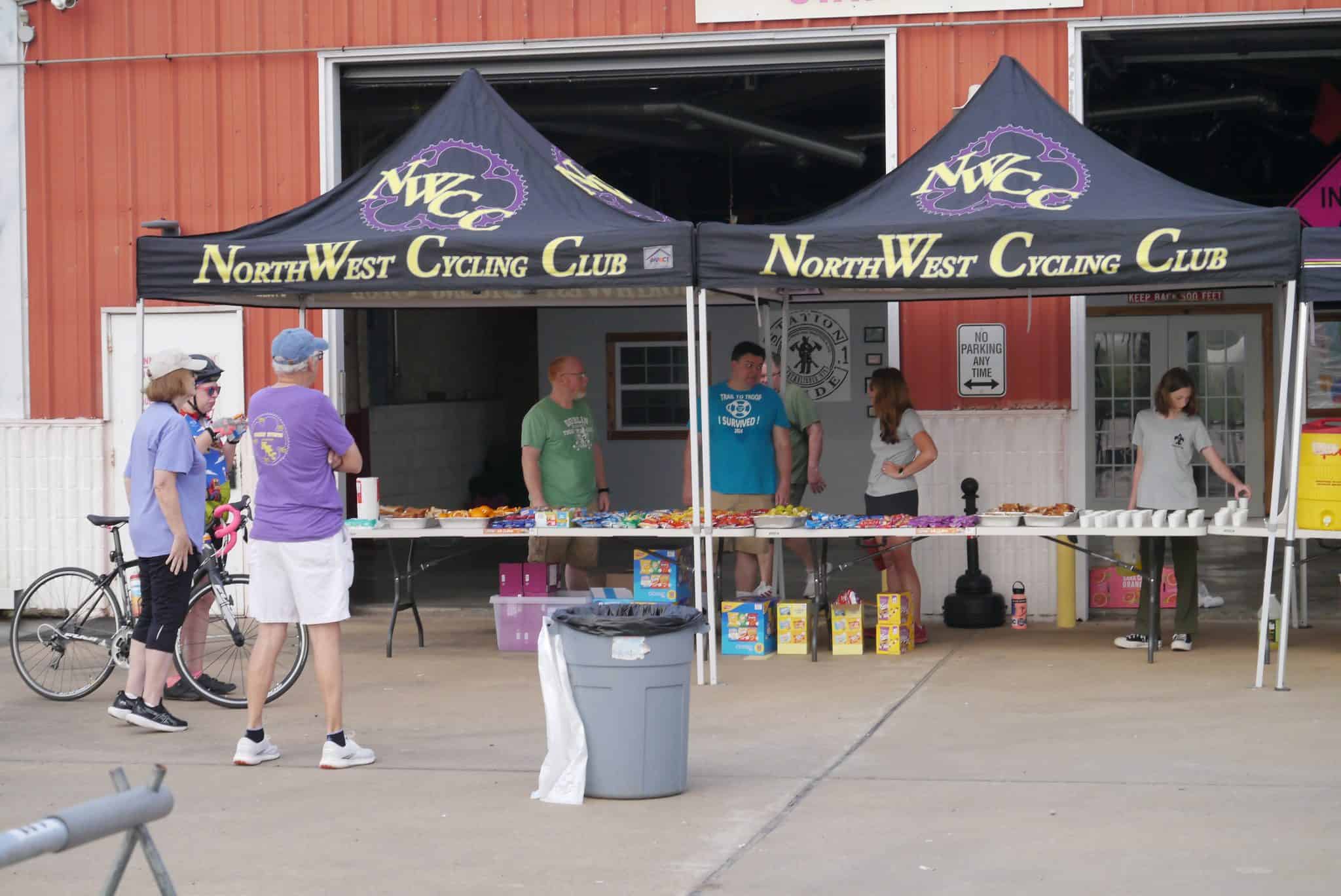 Bike riders at NorthWest Cycling Club snack stand during cycling event.