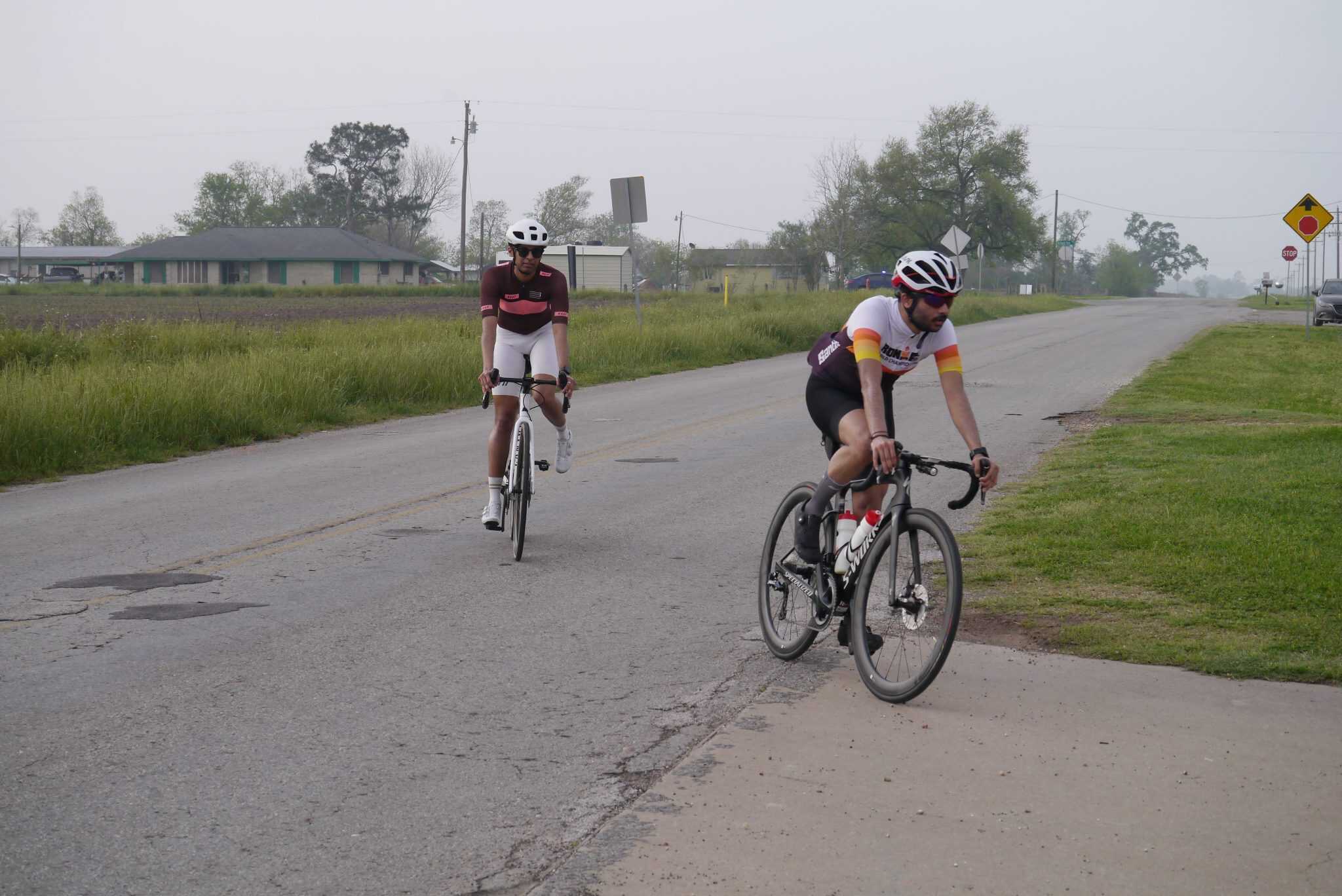 Riders on bikes in rural area, Bluebonnet Express cycling event, outdoor road cycling competition.