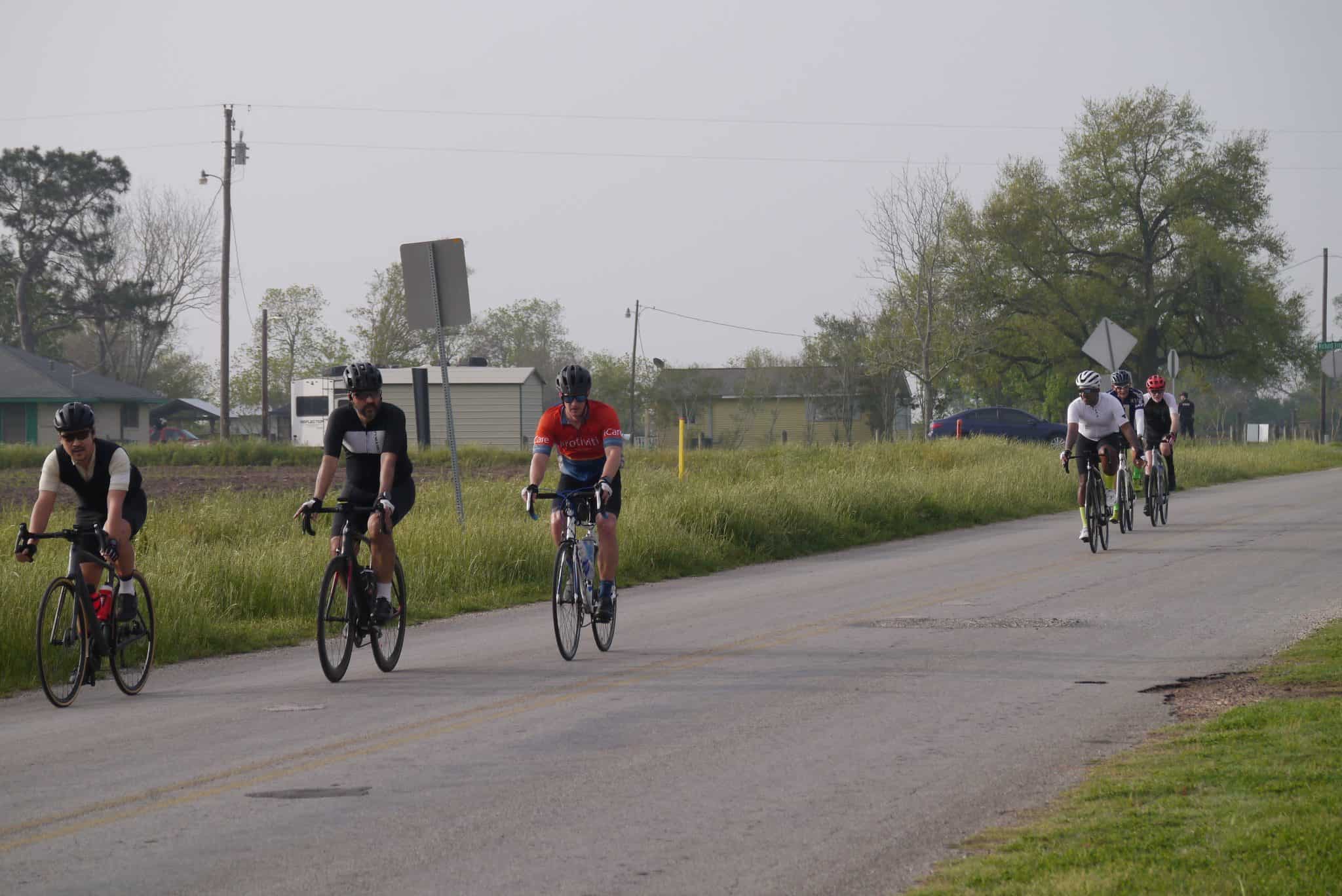 Multisport cyclists riding along rural road, Bluebonnet Express event, outdoor biking adventure.