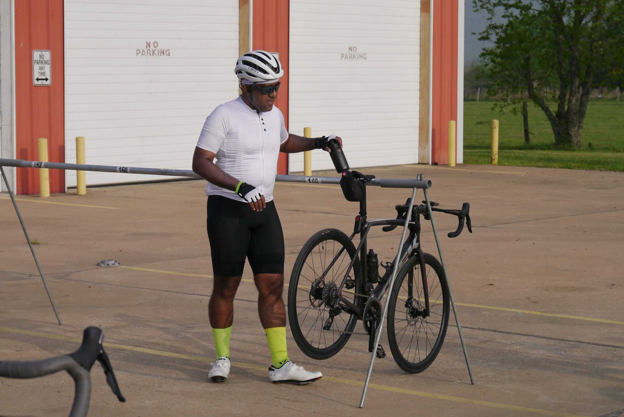 Bike rider refueling during Bluebonnet Express cycling event outdoors.