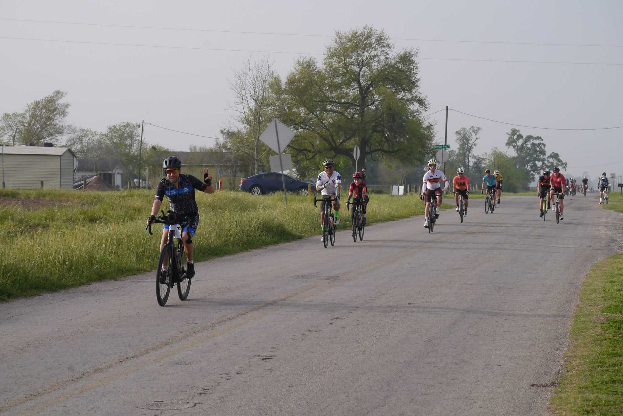 Cyclists riding on a rural road during Bluebonnet Express event, showcasing outdoor cycling adventure.