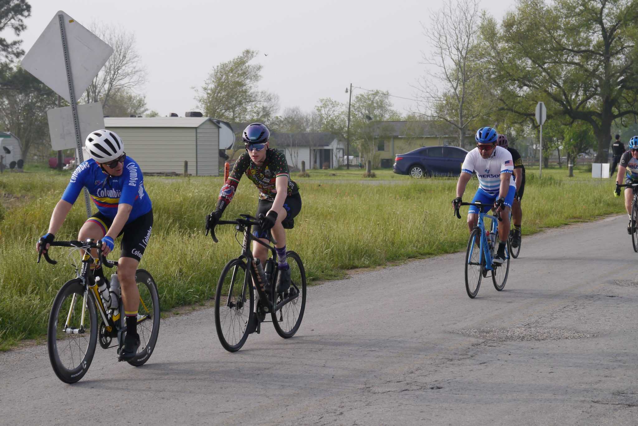 Cyclists riding on a rural road during the Bluebonnet Express event.