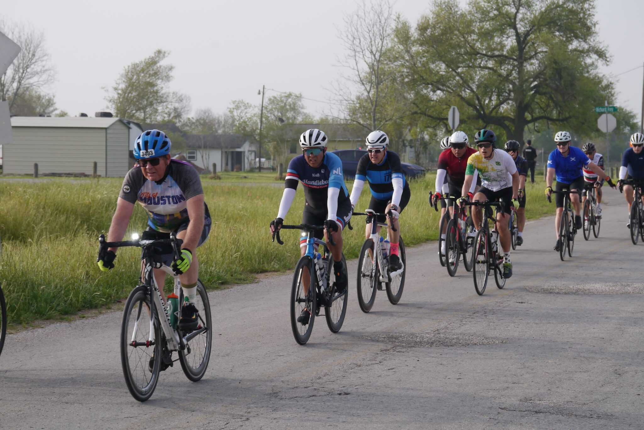 Vibrant group of cyclists enjoying Bluebonnet Express ride on rural road, promoting community cycling events.