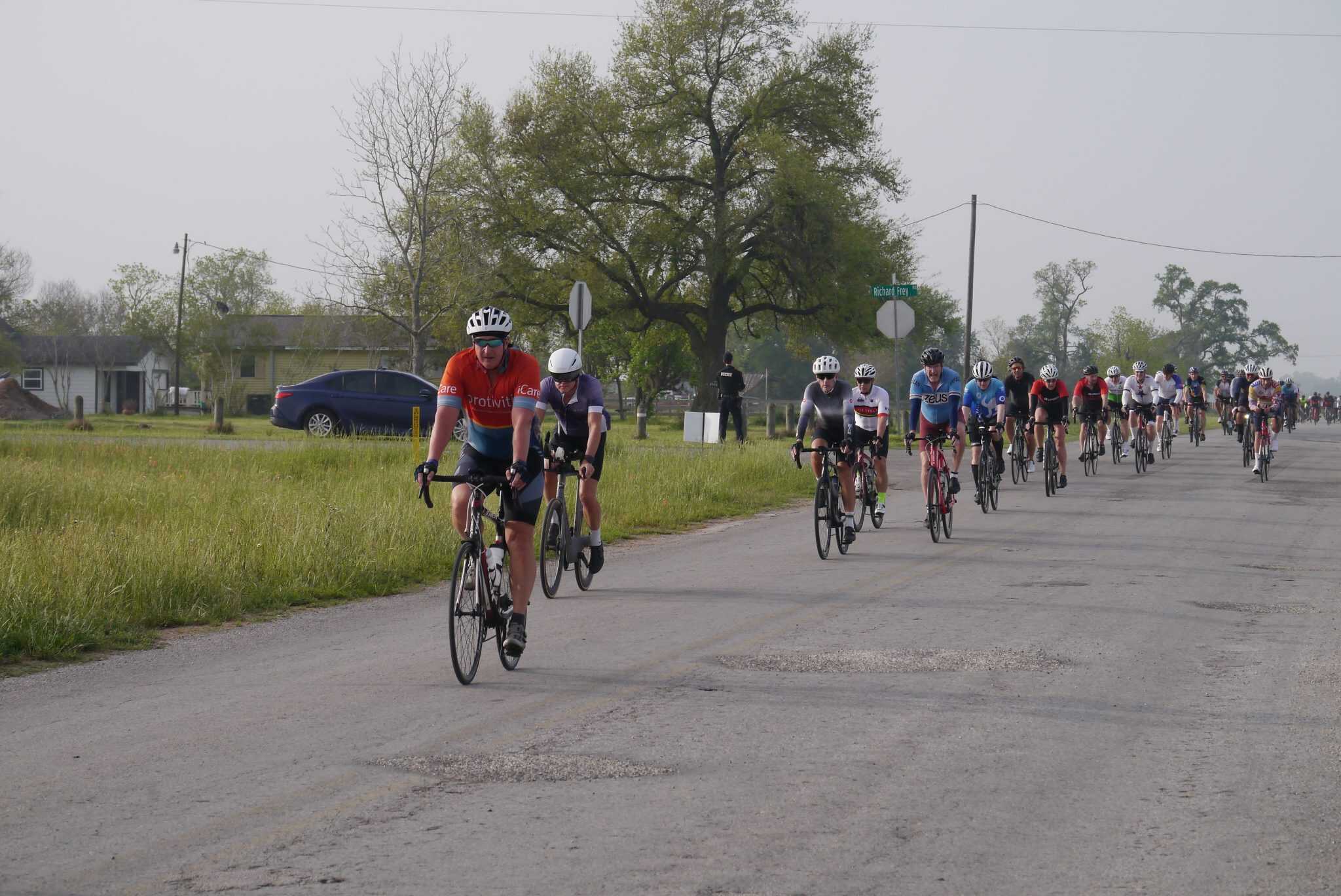 Cycling event on a rural road during daytime, showcasing Bluebonnet Express bike race for outdoor enthusiasts.