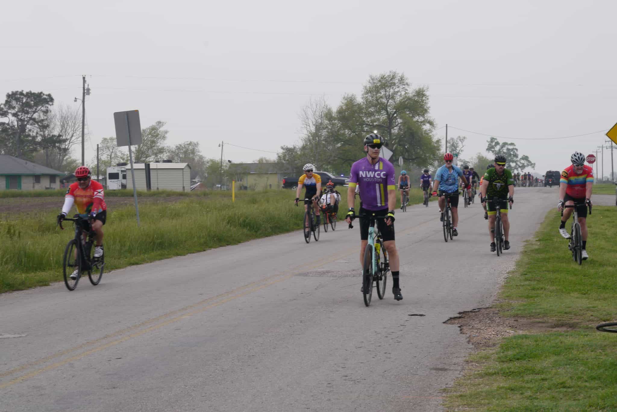 Cyclists riding on open road during Bluebonnet Express event in Texas.