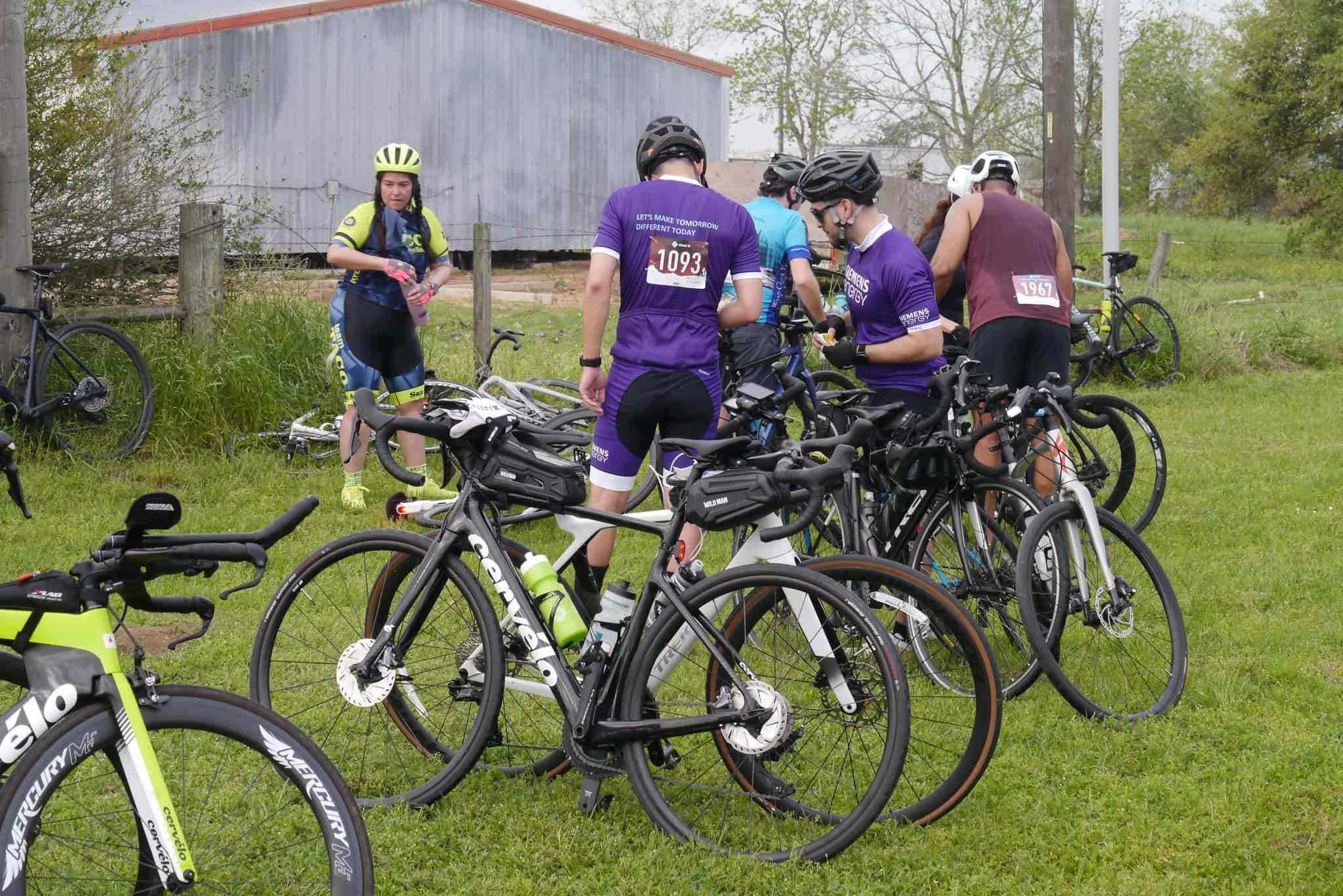 Bicycle group at Bluebonnet Express cycling event, with numerous bikes and riders preparing for ride.