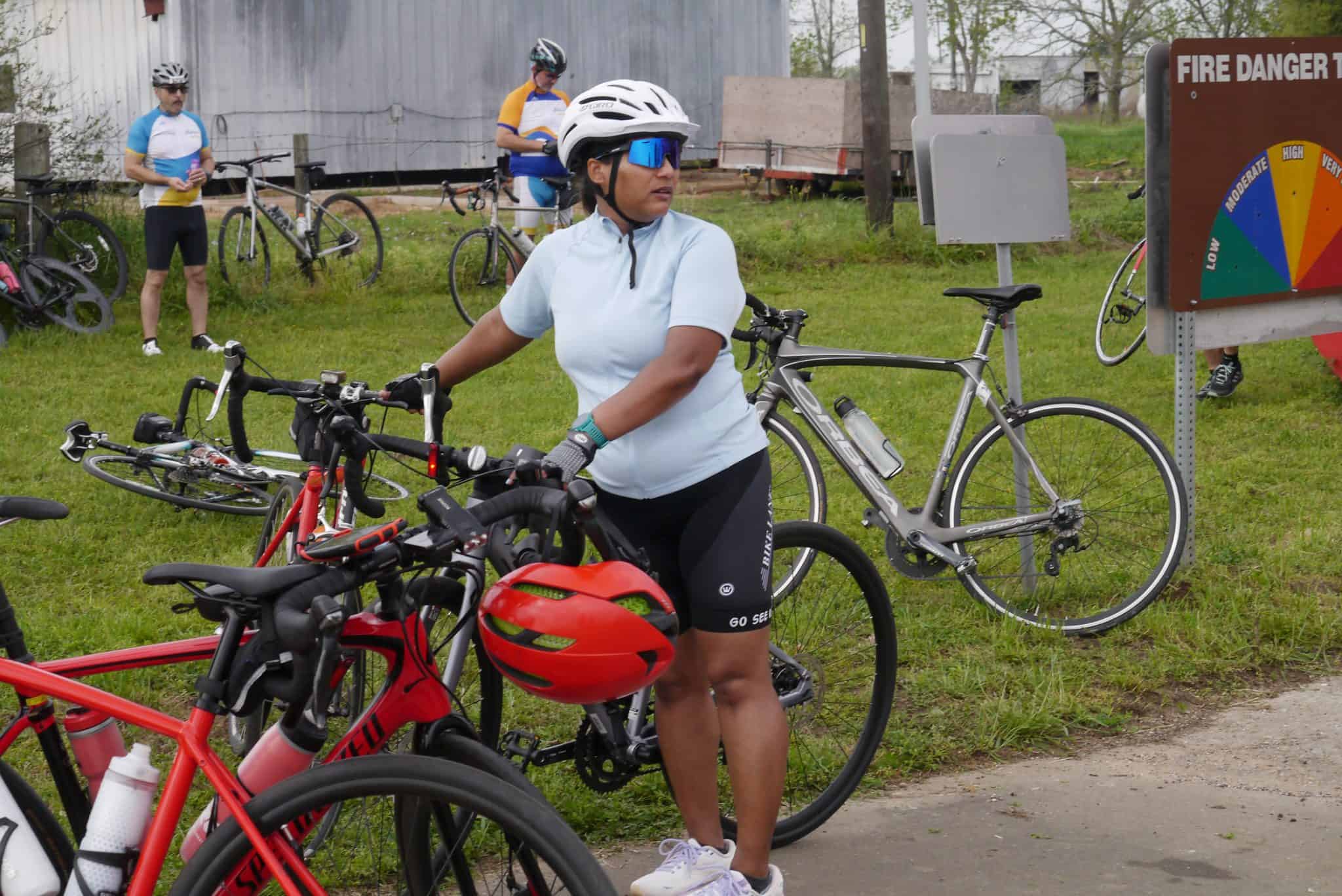 Bicycle riders preparing for a ride at Bluebonnet Express event, outdoor cycling activity, bikes and gear ready.