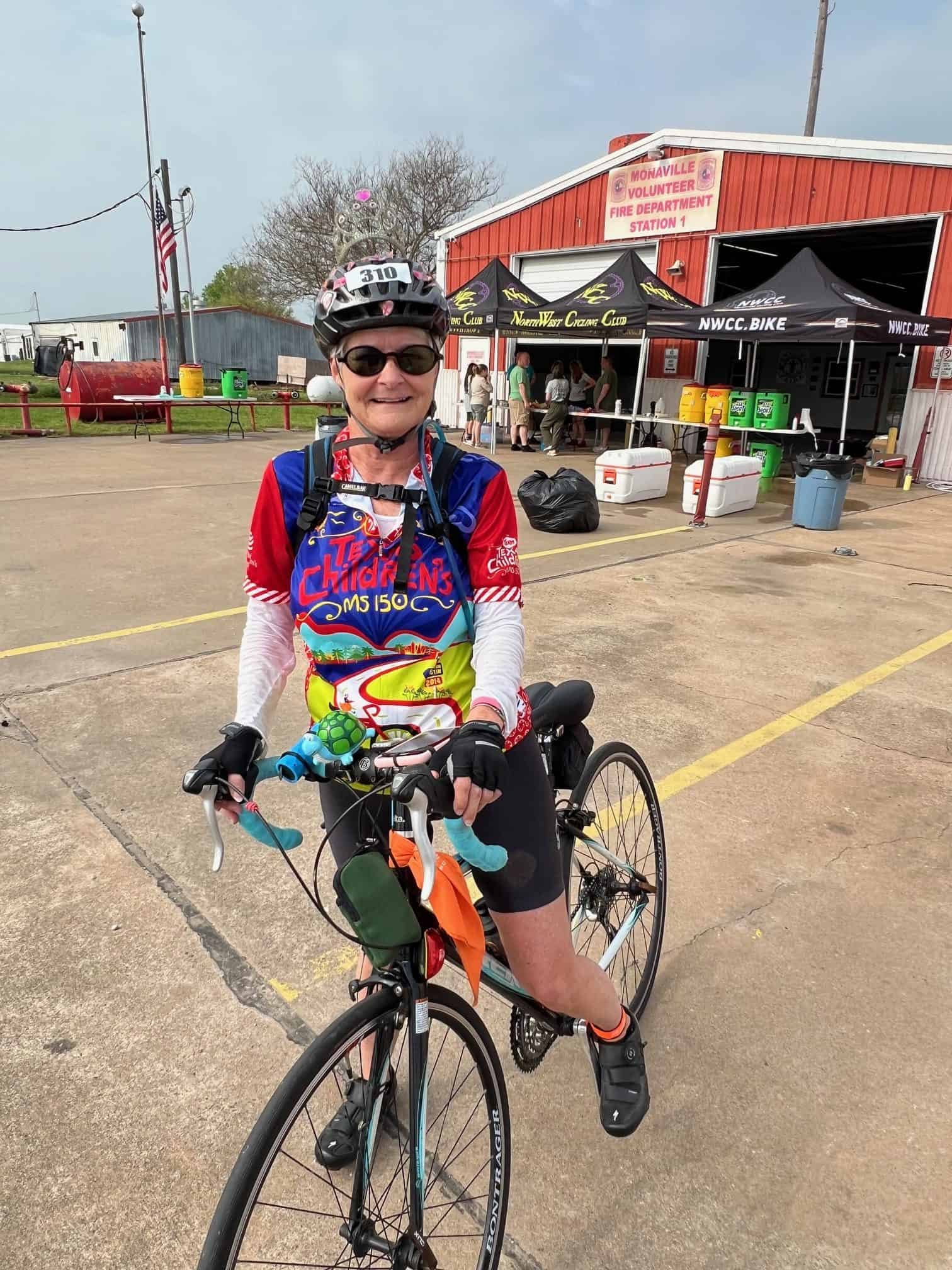 Joyful cyclist at Bluebonnet Express event, showcasing community cycling and scenic Texas biking routes.