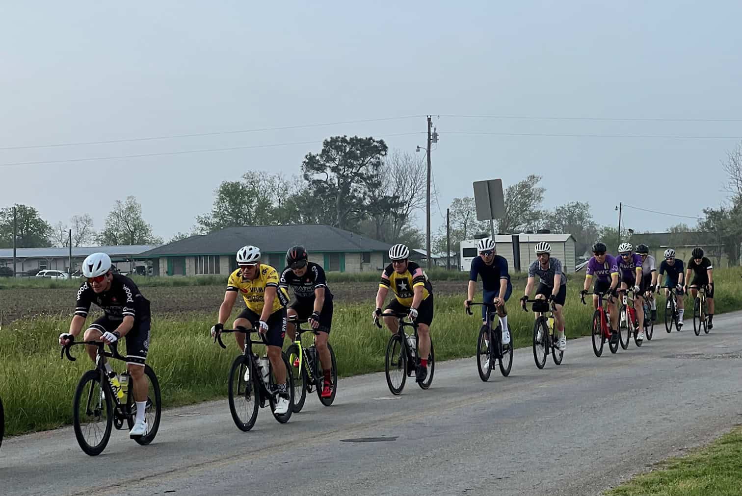 Cyclists riding together on a rural road during daytime for Bluebonnet Express event.