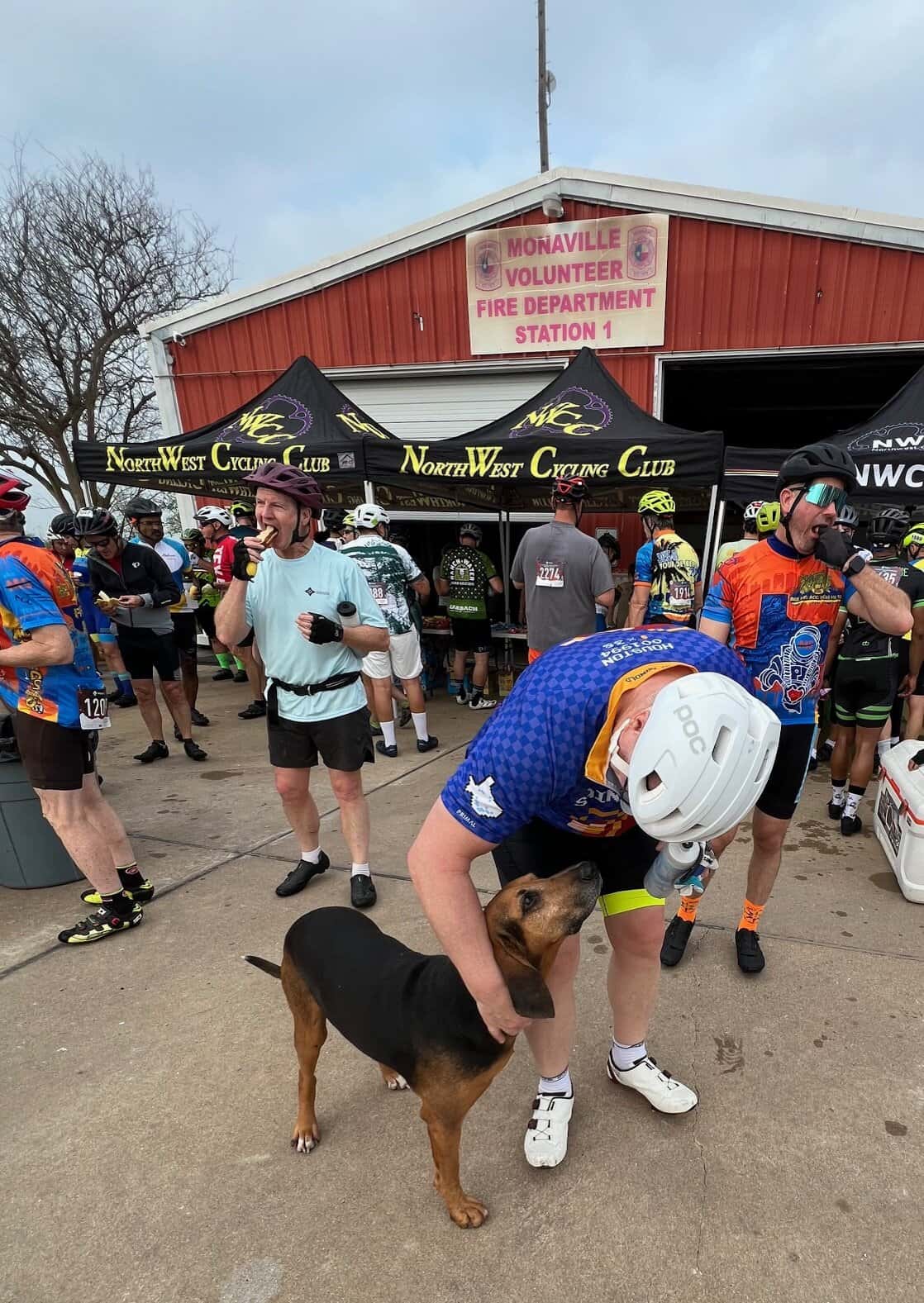 Happy cyclist with a dog at Bluebonnet Express cycling event, community support for cycling and outdoor activities.