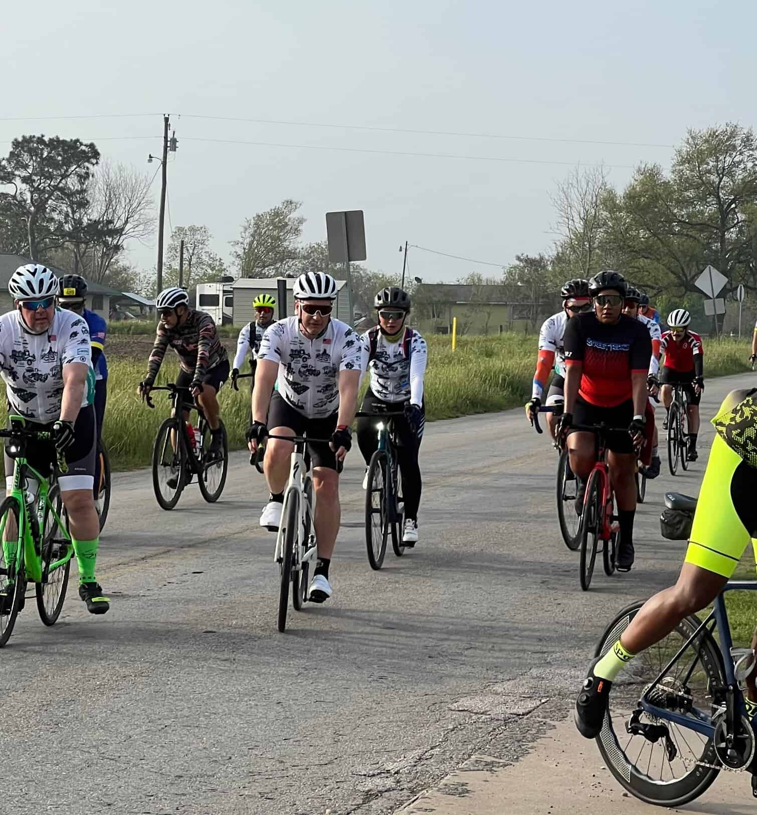 Bicycle group riding on open road, promoting Bluebonnet Express bike transportation and eco-friendly travel solutions.