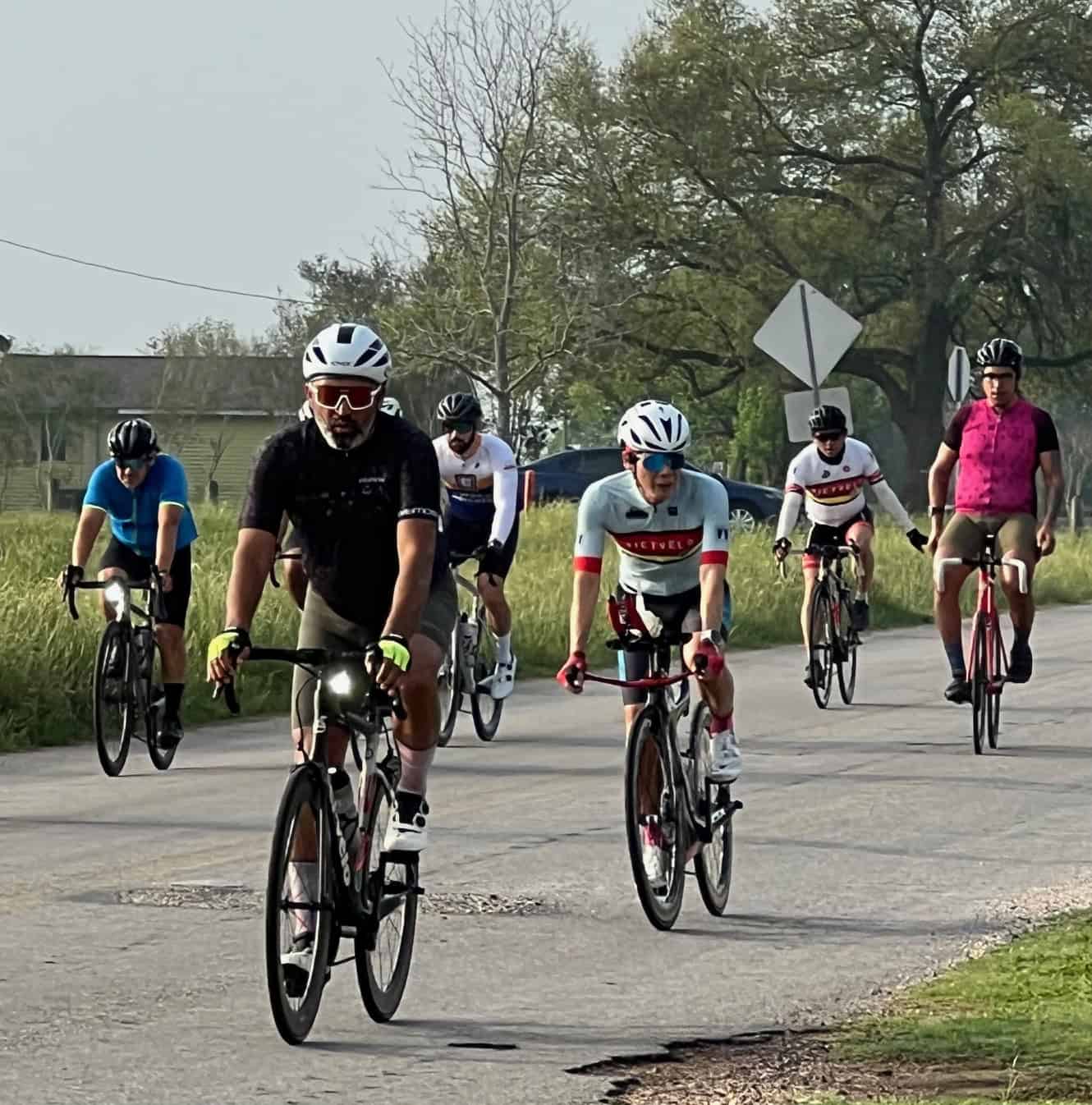 Vibrant group of cyclists enjoying a ride with Bluebonnet Express on a scenic outdoor trail.