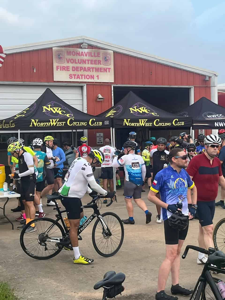 Cyclists gathering at Bluebonnet Express event in front of Monaville Volunteer Fire Department.