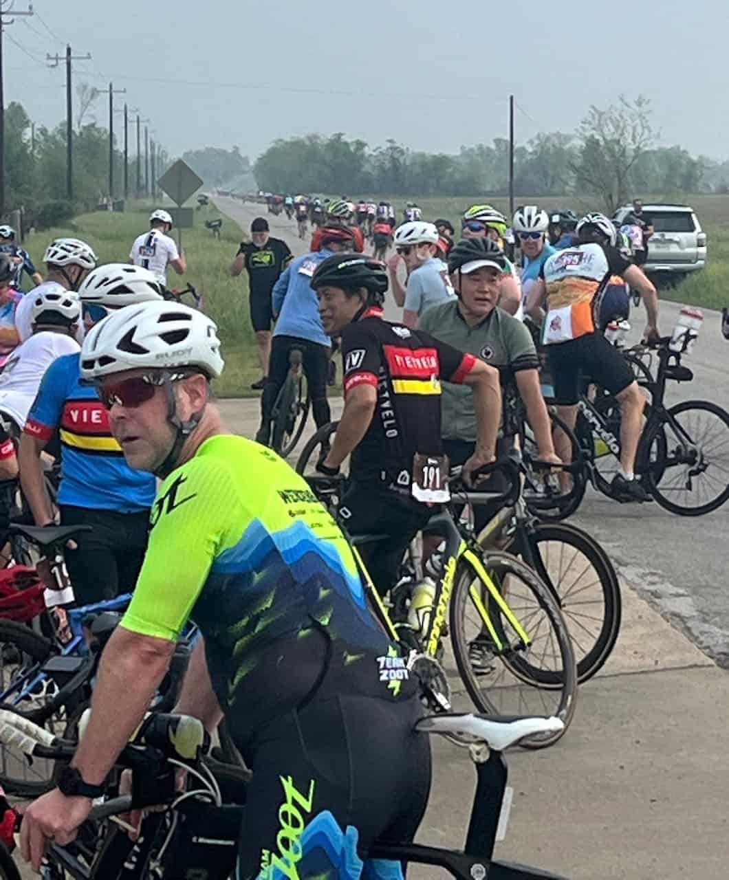 Cycling event on rural road with many participants, scenic outdoor, Bluebonnet Express bike race.