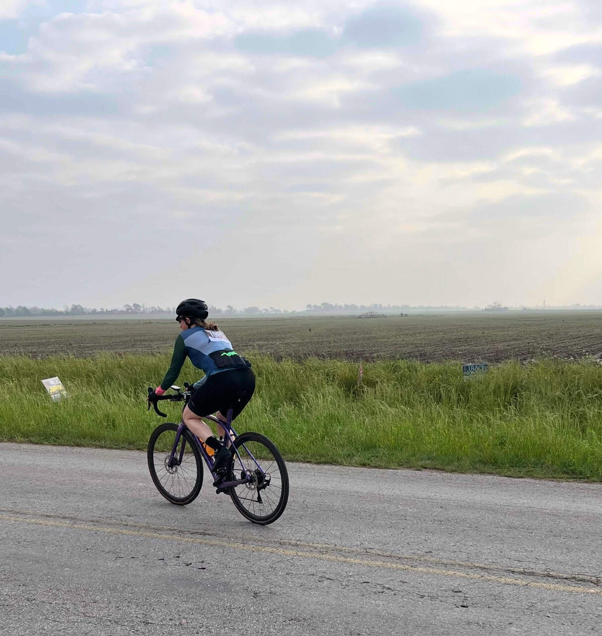 Vast open fields with cyclist enjoying a scenic ride on the Bluebonnet Express bike route.